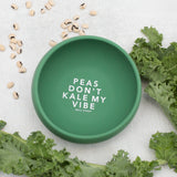 Top View of Bella Tunno bowl with Peas don't kale my vibe saying surrounded by kale
