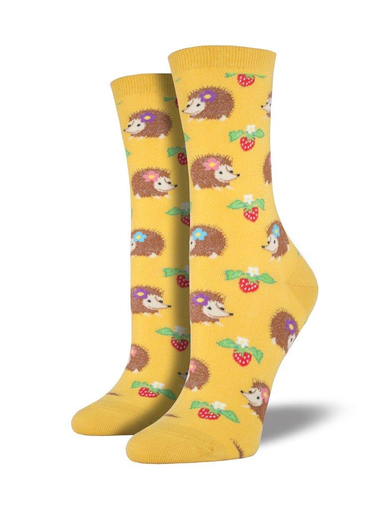 Gold colored socks featuring hedgehogs and strawberries