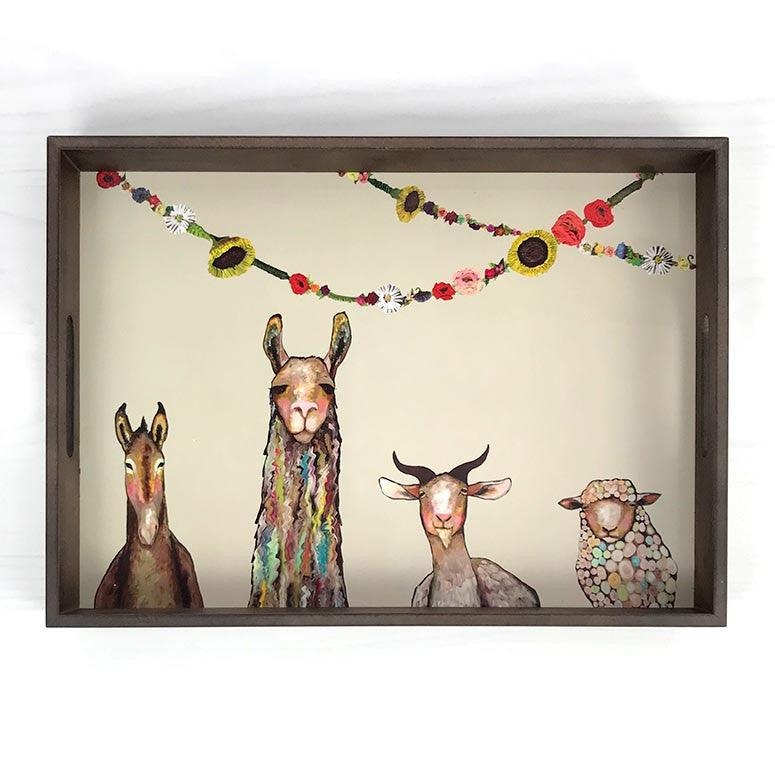 Under two draping strands of colorful flowers, a donkey, llama, goat and a sheep painted in various colors and styles facing forward.