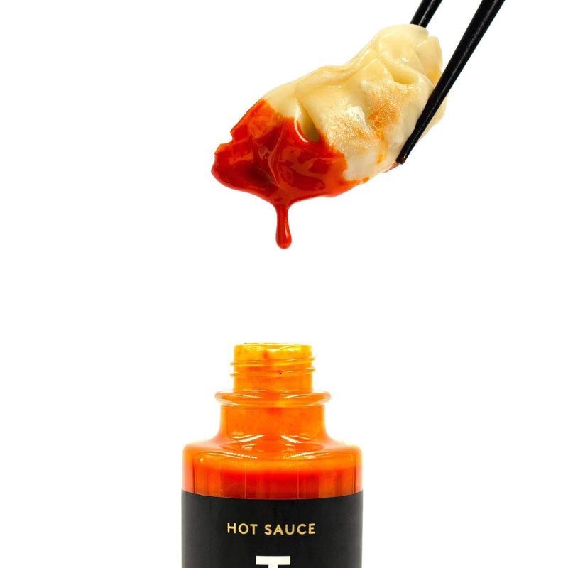 Truff Hot Sauce bottle with gyoza